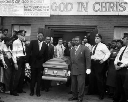 Black and white photo of pawbearers carrying Emmett's casket